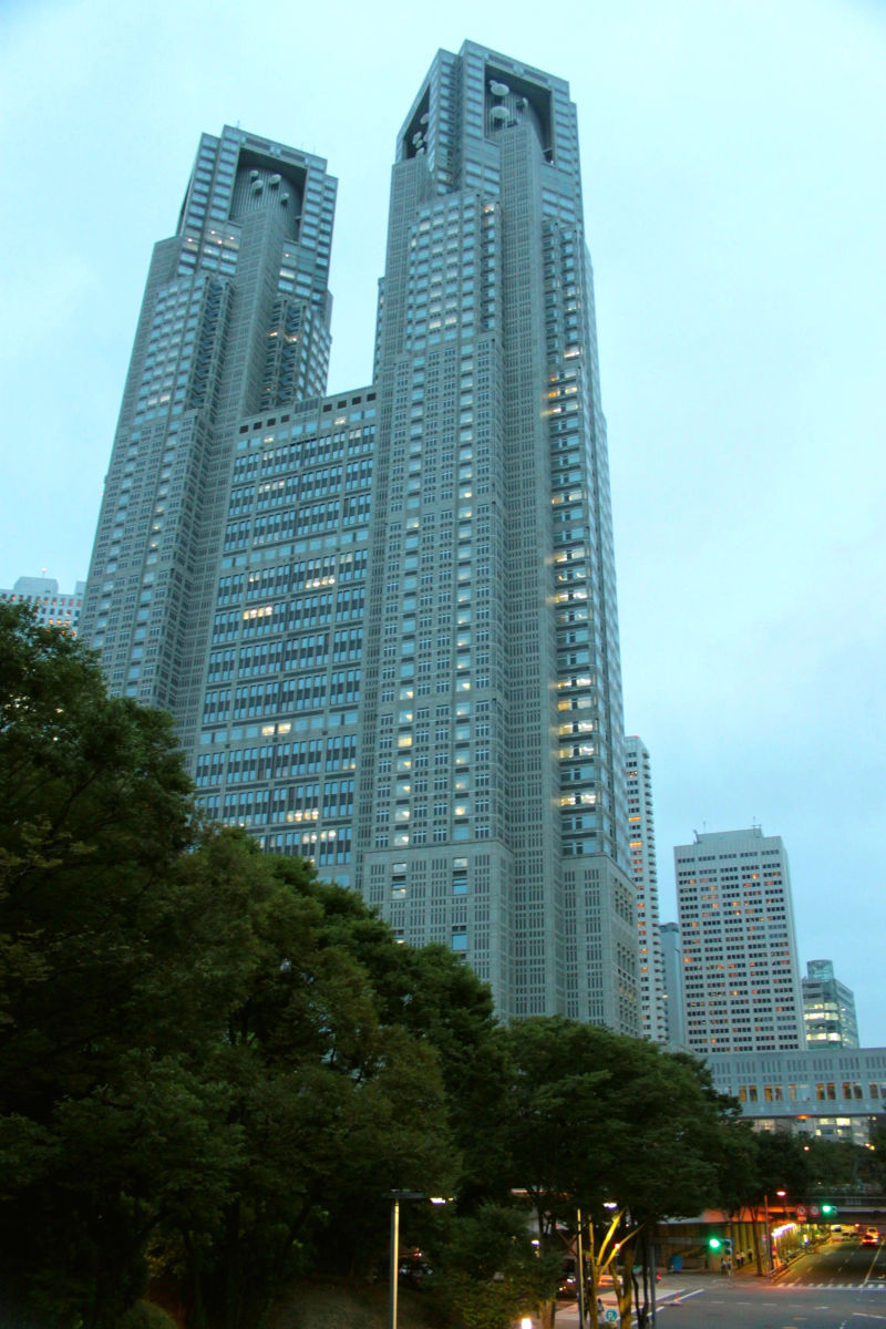 Nowoczesny budynek rządowy w dzielnicy Shinjuku, otoczony drzewami.