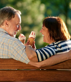 An old couple enjoying ice cream.