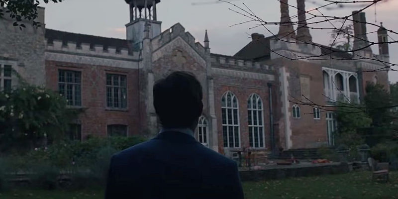 Jude Law standing in fron of the house in The Nest