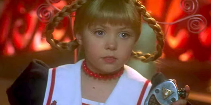 Cindy Lou (Taylor Momsen) holding up a recording device in How the Grinch Stole Christmas. 