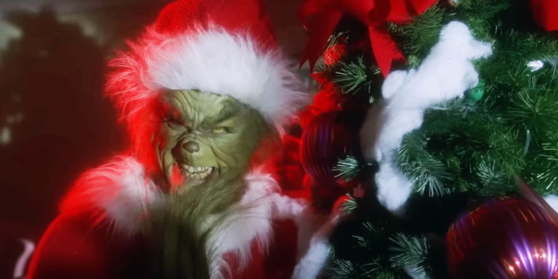The Grinch (Jim Carrey) stealing a Christmas Tree in 2000's How The Grinch Stole Christmas.