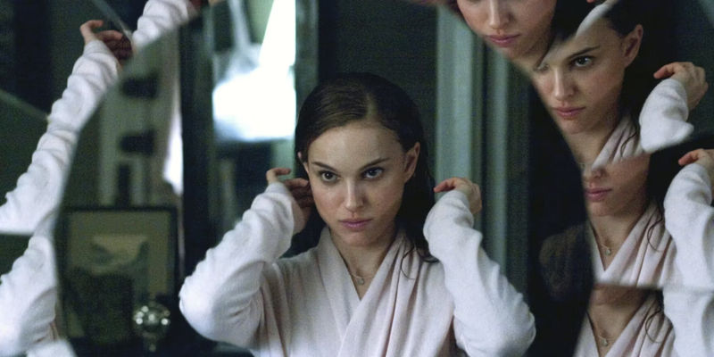 Nina Sayers (Natalie Portman) looking in a broken mirror in Black Swan