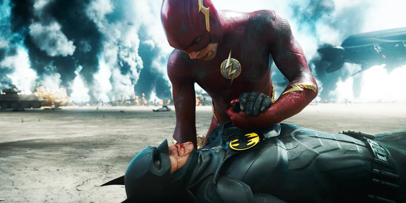 The Flash Barry Allen holding Keaton's Batman's hand as he dies