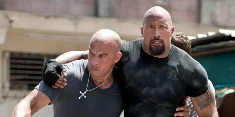 Dom (Vin Diesel) and Hobbs (Dwayne Johnson) carrying each other in Fast Five.