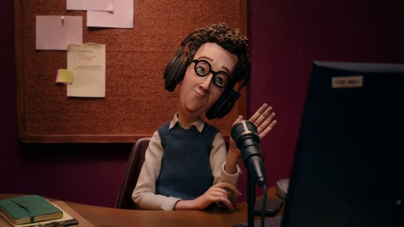 In The Know's Lauren speaking at a microphone with headphones on.