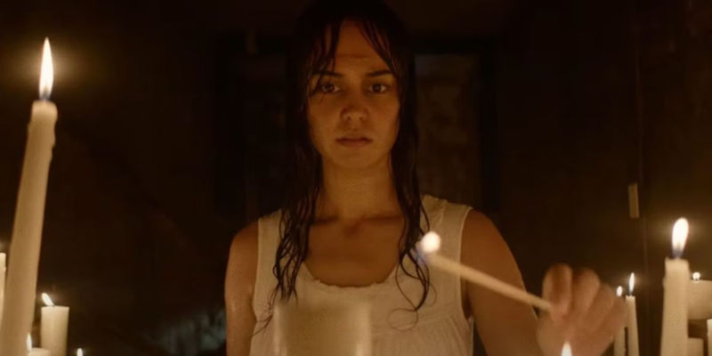 Lottie (Courtney Eaton) lighting candles during her vision in Yellowjackets season 1 episode 6 Saints.
