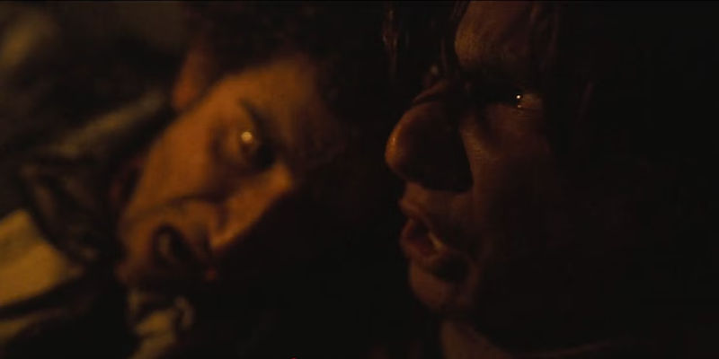 Avalanche scene in Society of the Snow with two frightened characters