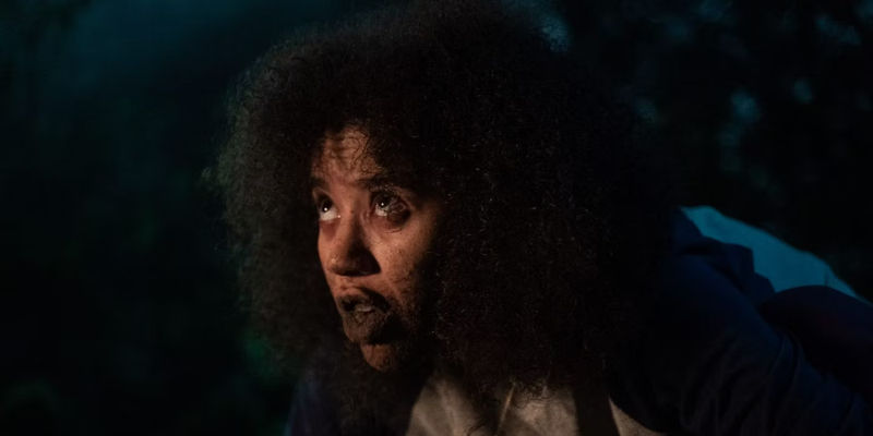 Taissa (Jasmin Savoy Brown) eating dirt in a vision in Yellowjackets season 1 episode 6 Saints.