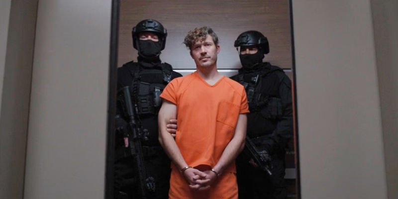 Voit dressed prison uniform and cuffed with guards flanking him in Criminal Minds_ Evolution