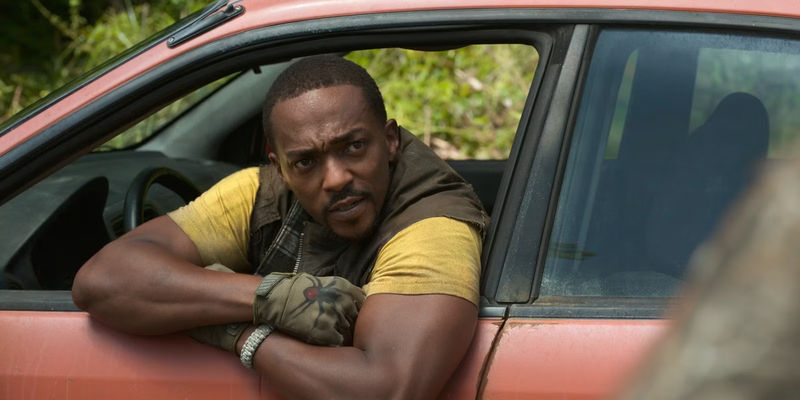 John Doe leans out the window of his car Evelyn when speaking to a person in Twisted Metal.