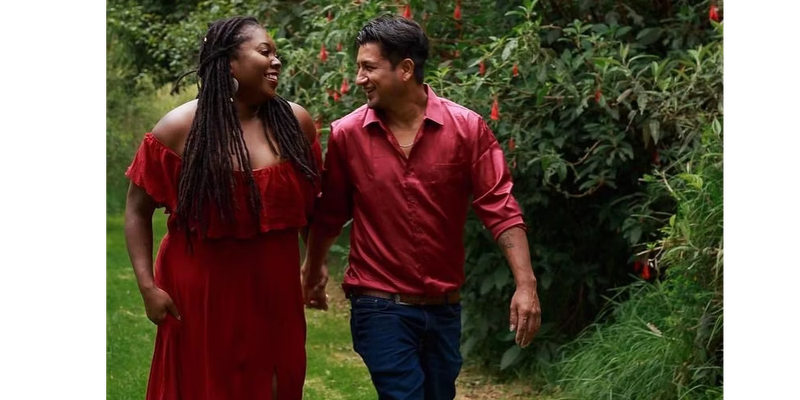 Manuel & Ashley 90 Day Fiance dressed in red and holding hands while walking