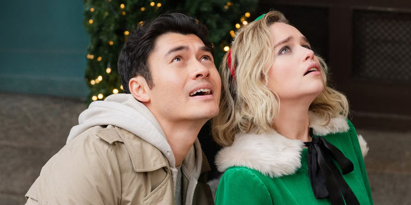 Henry Golding and Emilia Clarke looking up with apprehensive expressions in Last Christmas