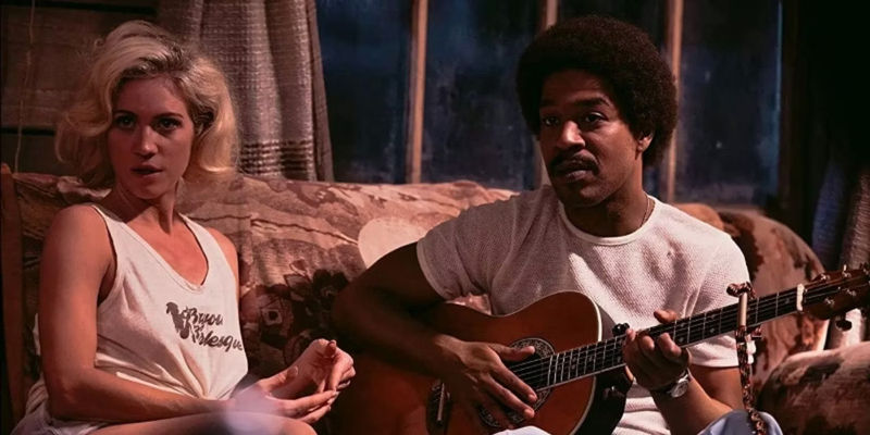 Brittany Snow as Bobby-Lynne and Scott Mescudi as Jackson Hole sit together in a scene from X.