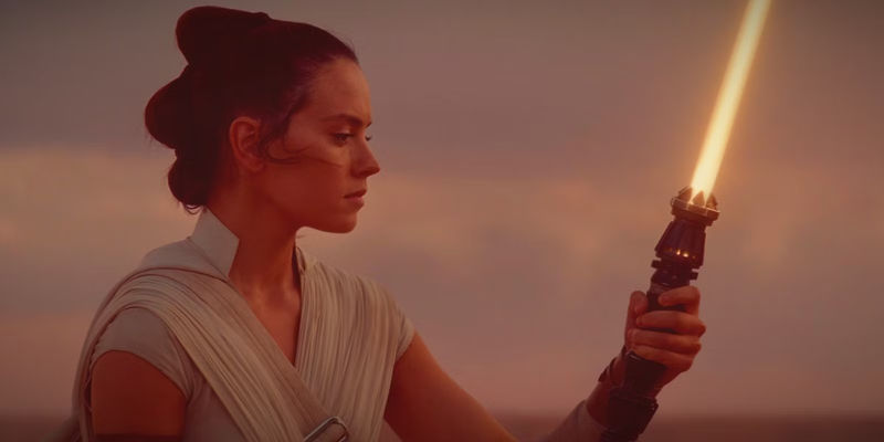 Rey Skywalker holding her lightsaber in The Rise of Skywalker
