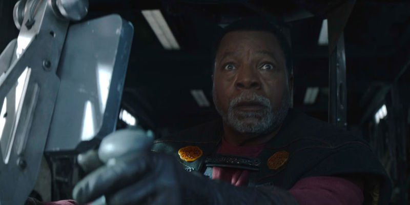Carl Weathers as Greef Karga looks shocked at an approaching TIE fighter in The Mandalorian season 2 episode 4
