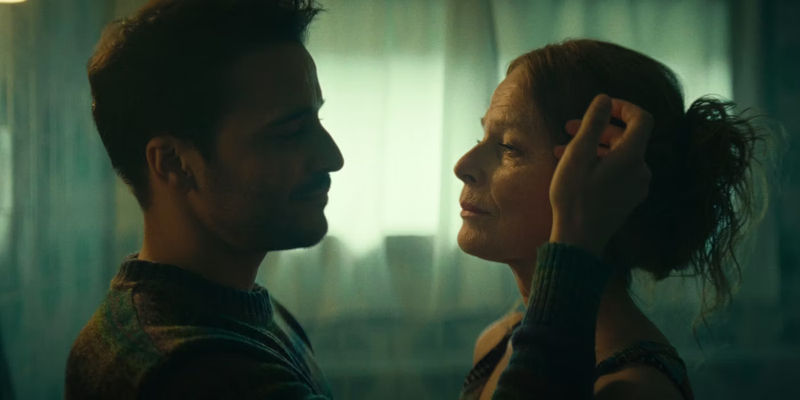 Max touching Elena's face in Paradise Netflix movie