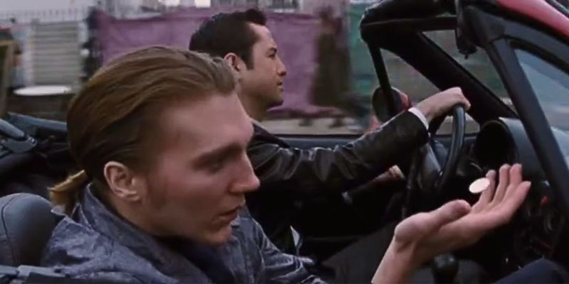 Paul Dano as Seth floating a coin in his palm in Joe's car in Looper
