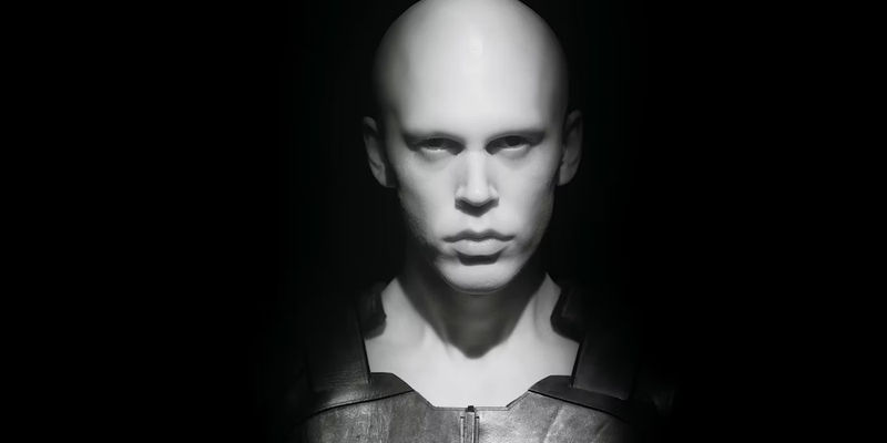 Austin Butler ghostly pale and gazing blank faced from the shadows in a dramatic scene from Dune: Part Two
