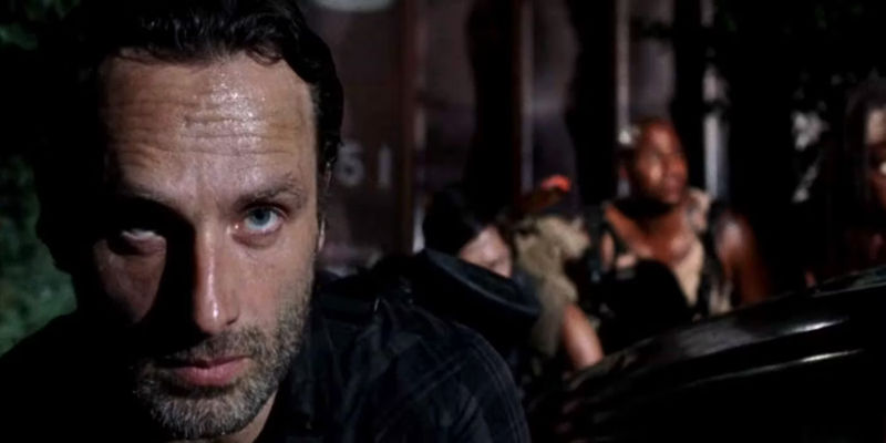 Rick and others hiding while scoping out Woodbury in The Walking Dead season 3 episode 8