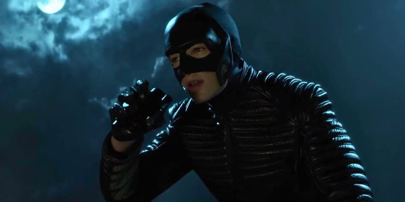 Bruce Wayne looking through binoculars wearing a mask in Gotham