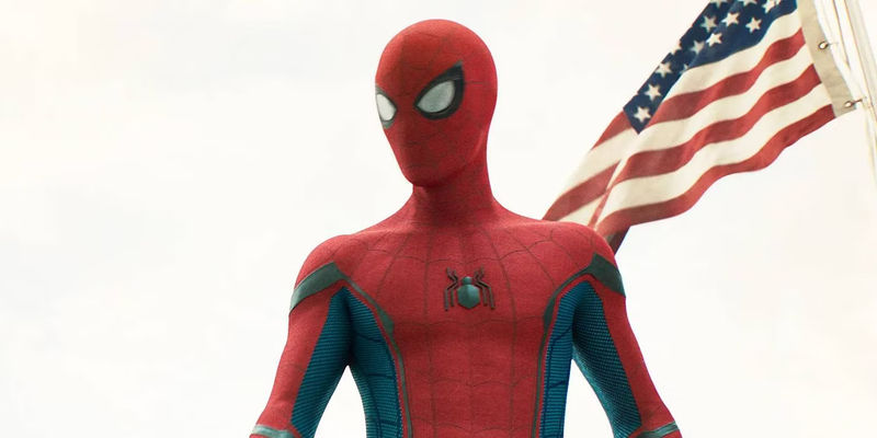 Tom Holland's Spider-Man stands in front of an American flag in Spider-Man: Homecoming