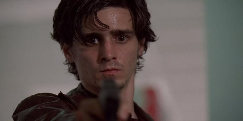 James Ransone as Ziggy Sobotka aims a gun at an off-screen civilian in The Wire.