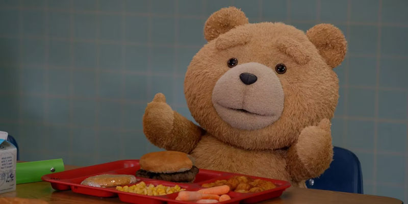 Ted gives thumbs up eating a school lunch in the Ted TV show