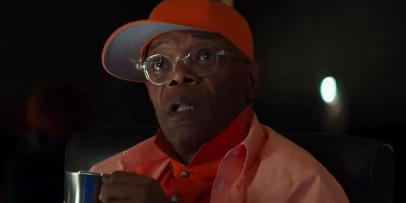 Richmond Valentine (Samuel L. Jackson) looking surprised and holding a coffee cup in Kingsman The Secret Service.