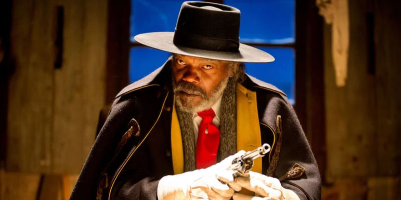 Samuel L. Jackson as Major Marquis Warren holding his gun intently in The Hateful Eight