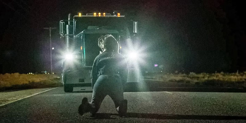A woman kneeling in front of an oncoming truck at night in The Little Things.
