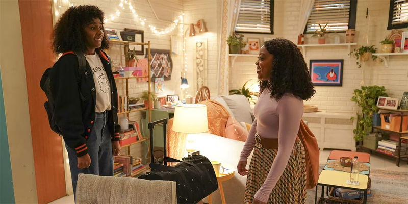 Janine (Quinta Brunson) and Ayesha (Ayo Edebiri) stand awkwardly in Janine's apartment in Abbott Elementary. 