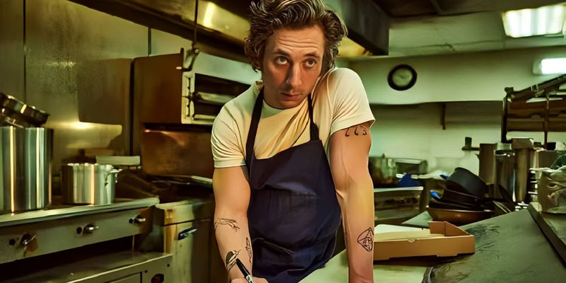 Carmy (Jeremy Allen White) holds a pen while looking up in The Bear.