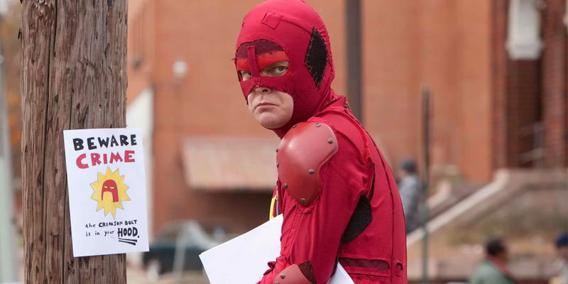 An image of the Crimson Bolt (Rainn Wilson) looking sad in Super