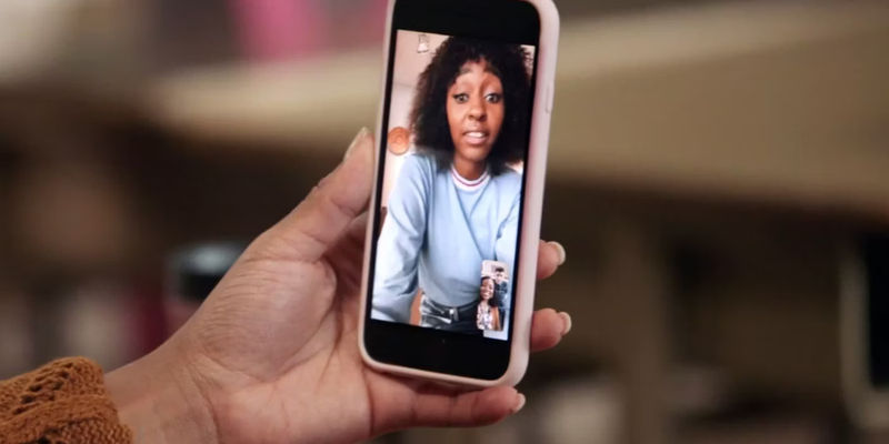 Janine (Quinta Brunson)'s hand holds up her phone while FaceTiming with Ayesha (Ayo Edebiri) in Abbott Elementary