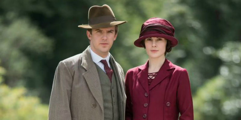 Lady Mary and Matthew Crawley standing close together and looking at the camera in Downton Abbey