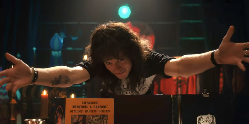 Joe Quinn as Eddie Munson extending his hands in Stranger Things Season 4