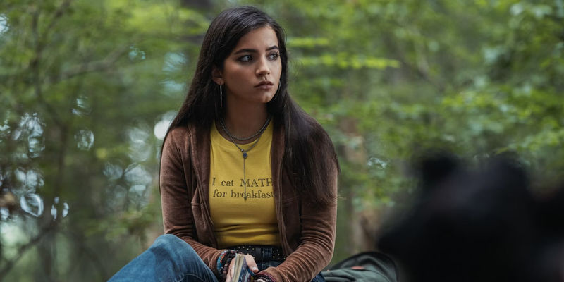 Anya sits in the forest in Madame Web