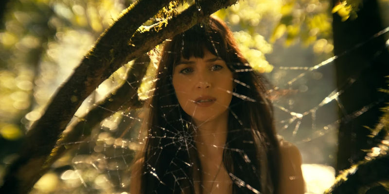 Dakota Johnson as Cassie Web stares at a spider's web in Madame Web