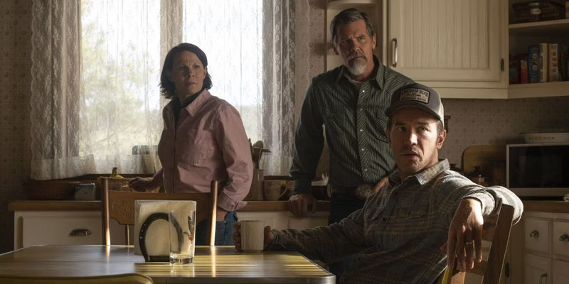 Royal, Cecelia, and Perry all sitting and standing around a kitchen table and looking confused in Outer Range.