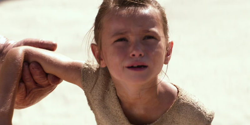 Young Rey looks distressed with Unkar Plutt holds her arm