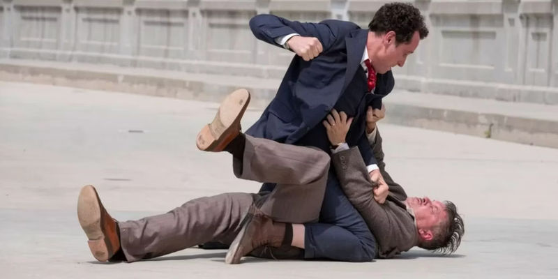 Perry Mason (Matthew Rhys) punching Pete (Shea Whigham) on the ground in Perry Mason.