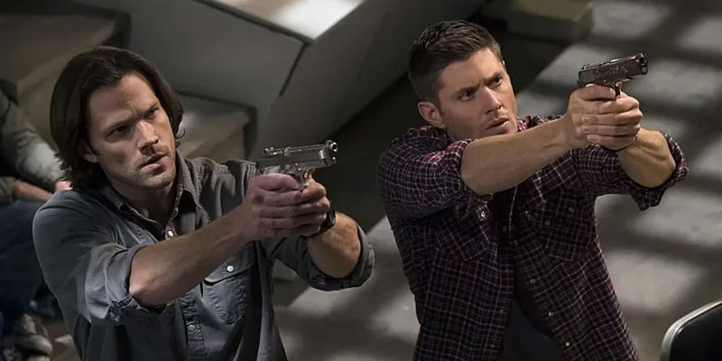 Sam and Dean with guns in Supernatural