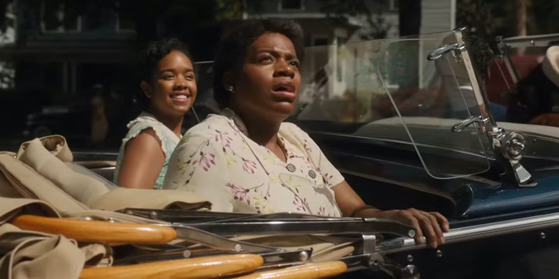 The Color Purple characters looking in awe in the back of a convertible 