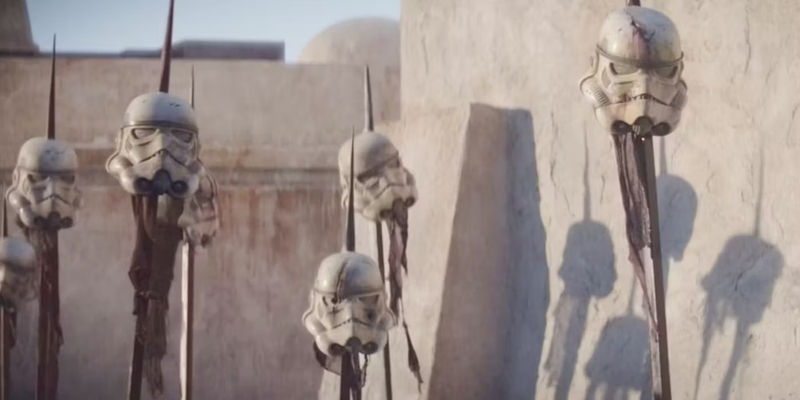 Stormtrooper helmets mounted on spikes on Tatooine in The Mandalorian
