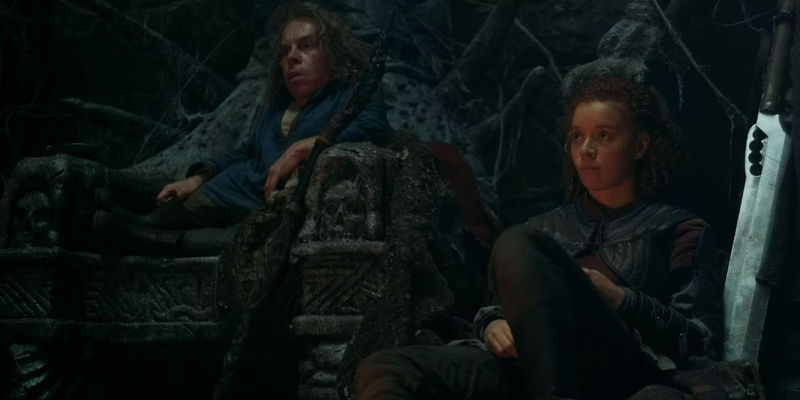 Willow (Warwick Davis) and Jade (Erin Kellyman) sitting down exhaused in the Nockmaar Castle in Willow.