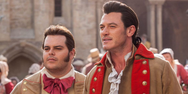 Gaston (Luke Evans) and LeFou (Josh Gad) standing outside in Beauty and the Beast