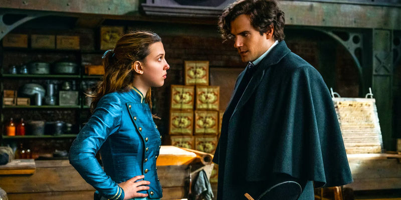 Millie Bobby Brown as Enola Holmes stares up at Henry Cavill as Sherlock Holmes in a scene from Enola Holmes 2.