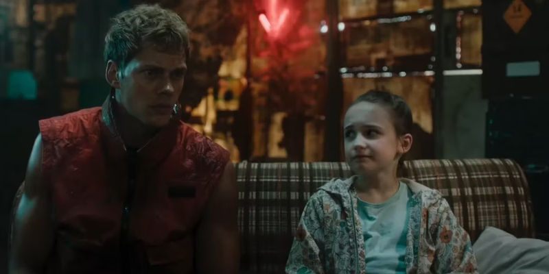 The Boy sits next to a child