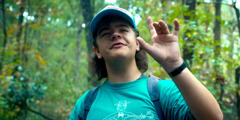 Gaten Matarazzo as Dustin Henderson Holding Up His Hand in the Woods in Stranger Things Season 4 - Broadway Debut: Priscilla Queen of the Desert