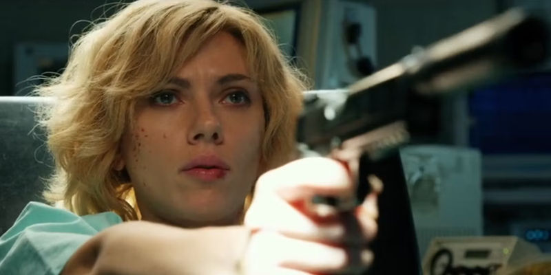 Lucy (Scarlett Johansson) pointing a gun in Lucy - Broadway Debut: A View from the Bridge